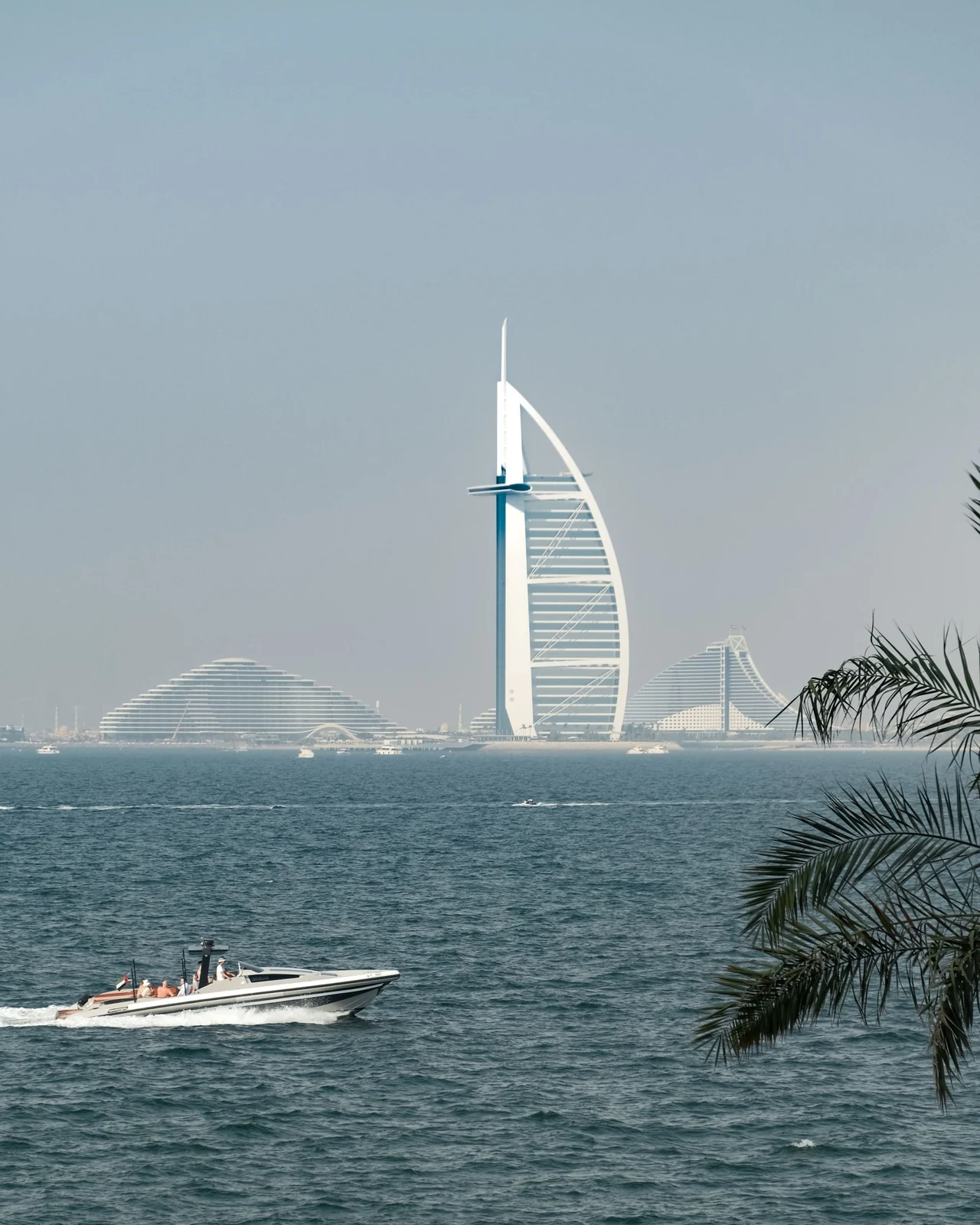 A motor boat crossing the water in front of Burj Al Arab