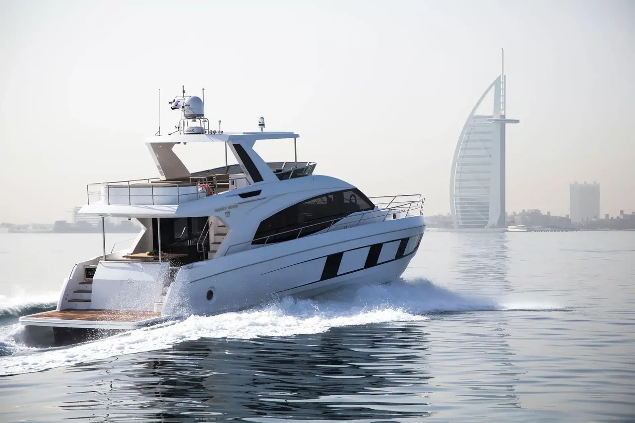 Alia 62 cruising with Burj Al Arab behind its stern