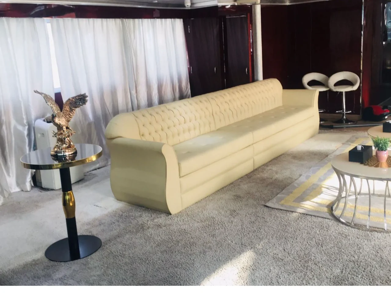 Pale upholstered lounge seating aboard Dream 100