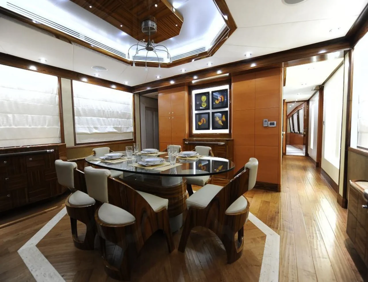 Indoor dining table with wood-finished cabinetry aboard Infinity 101