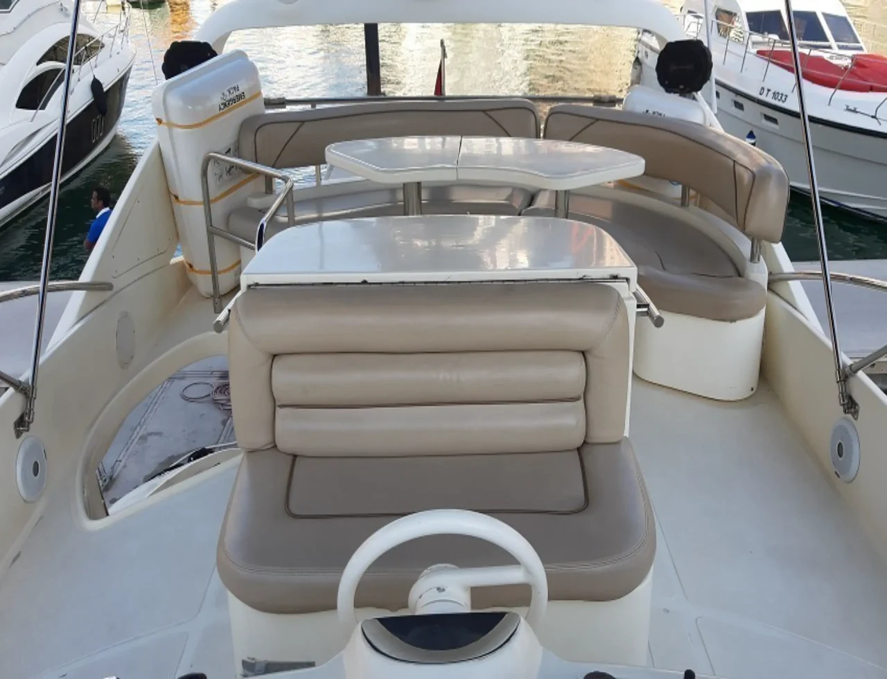 Upper helm seat and curved outdoor seating aboard Aicon 60