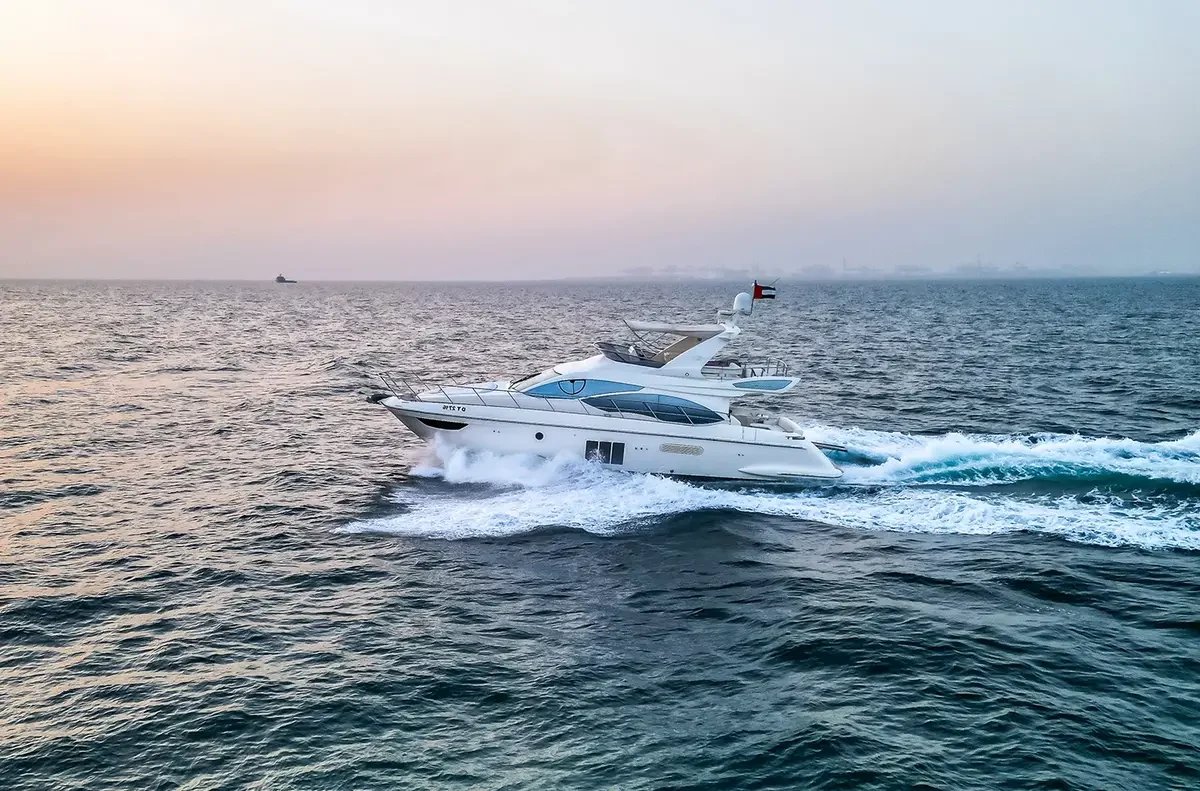 Eva 60 cruising across calm water in warm evening light