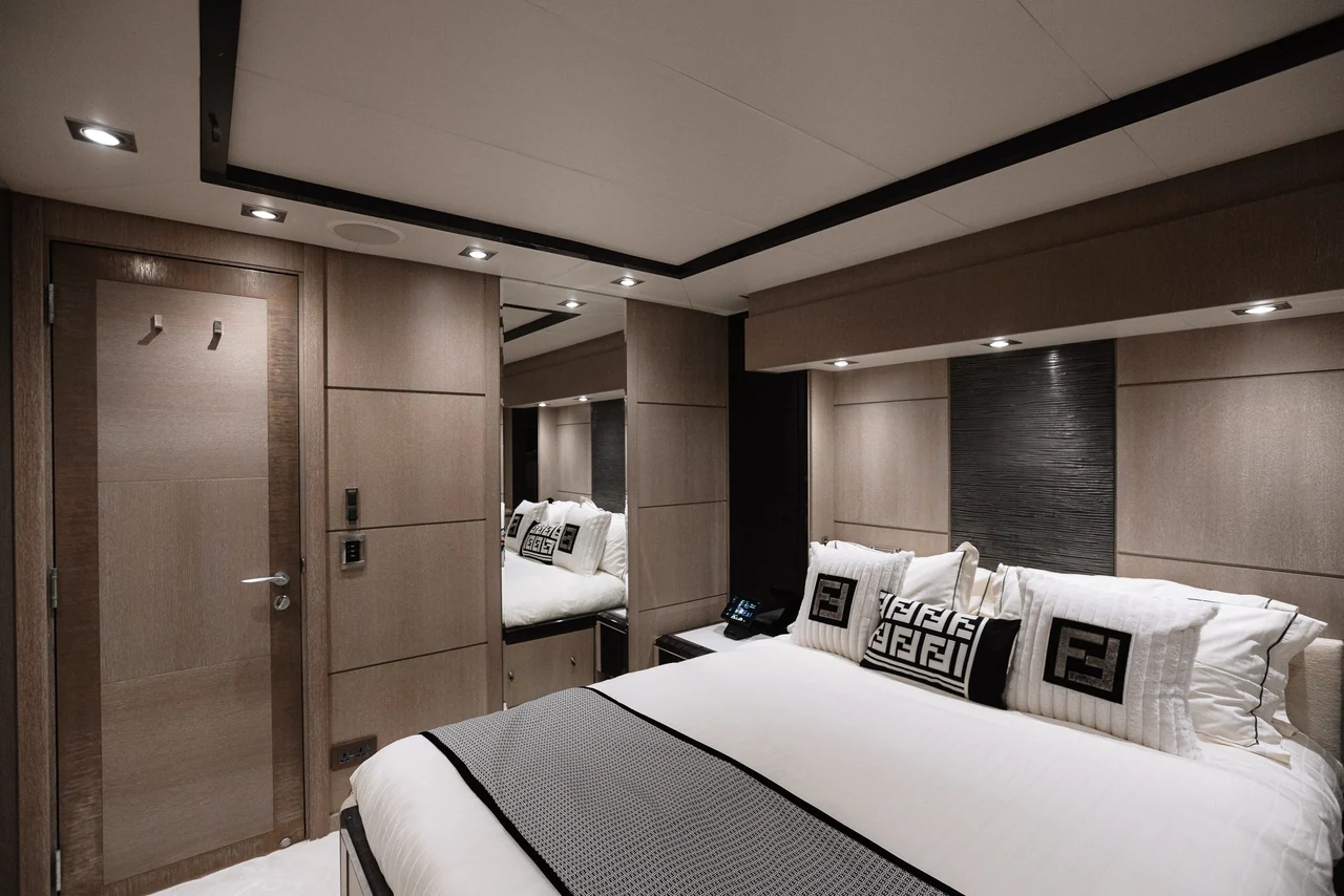 Double guest cabin with warm wood finishes aboard Royalty 136