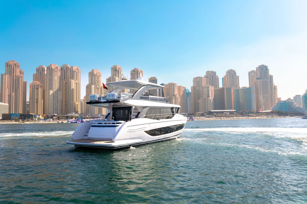 Apex underway with the Dubai waterfront behind the stern