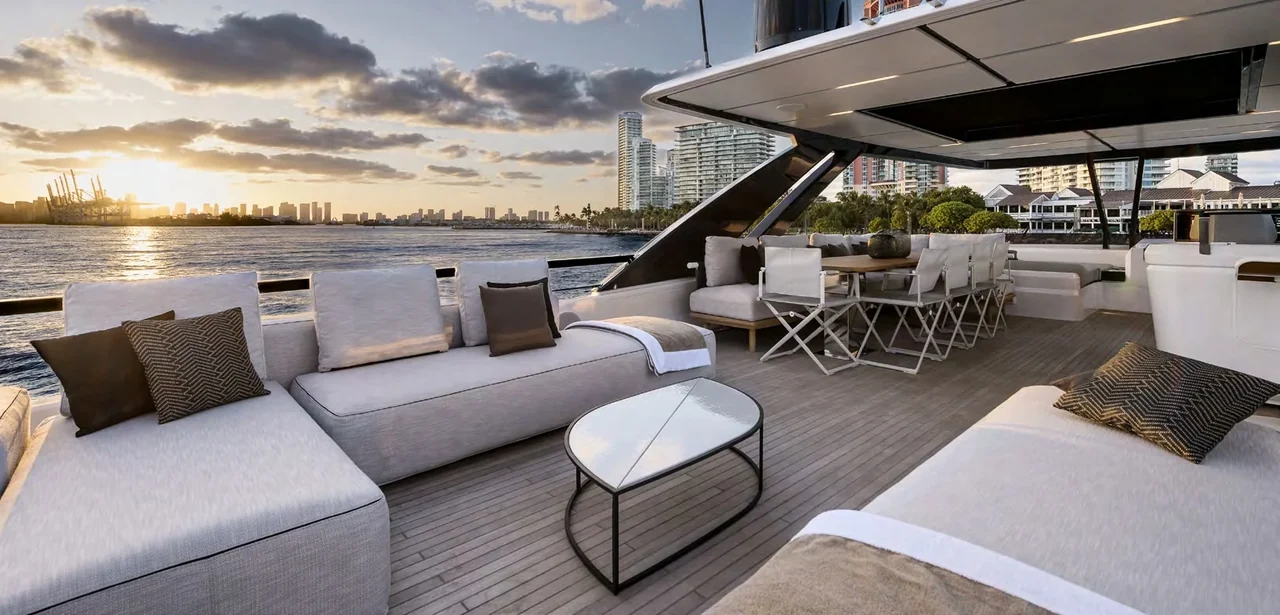 Outdoor lounge and dining area aboard Bella VIIII at sunset
