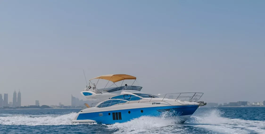 Blue-hulled Mia 48 underway beside the Dubai coast