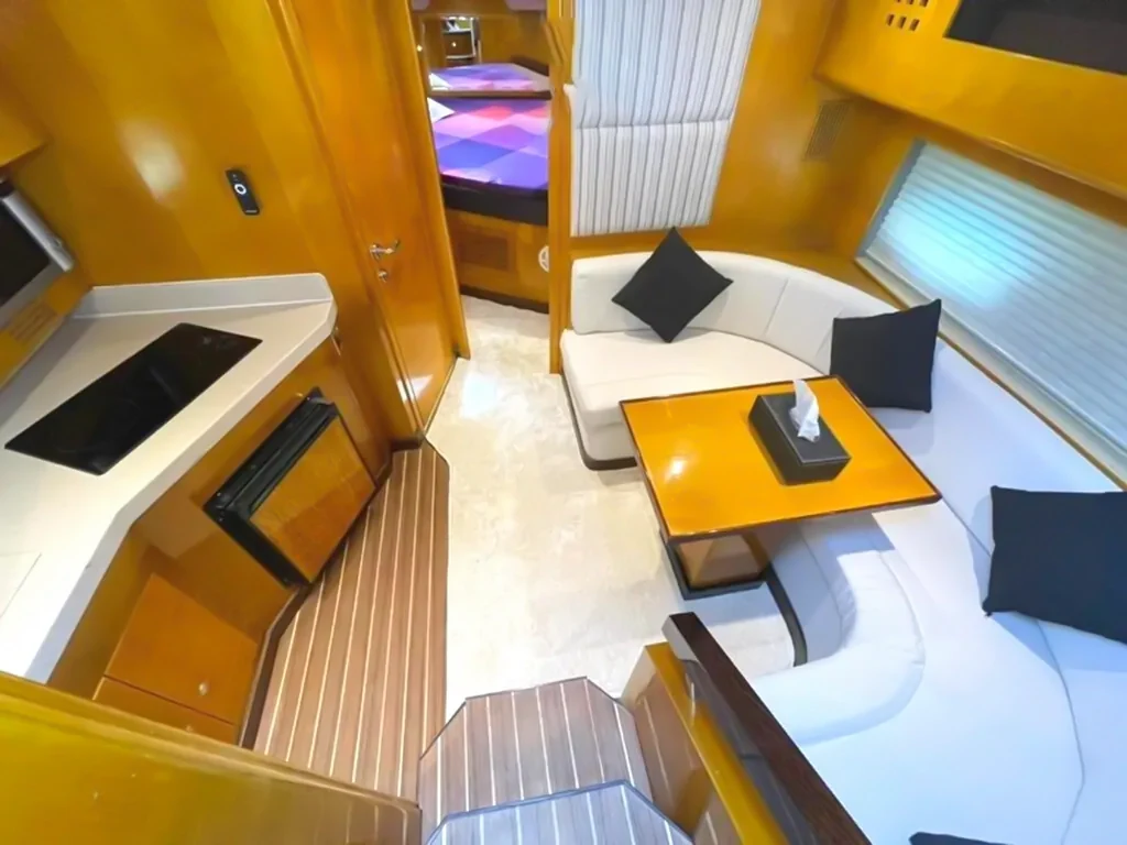 Compact indoor seating and table below deck on Oryx 36