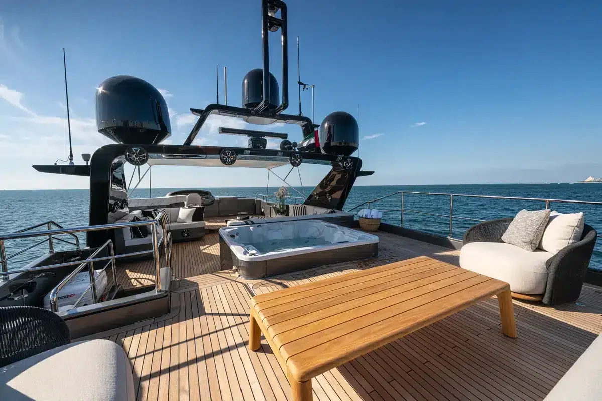 Jacuzzi, teak table and seating on Triple 7’s upper deck