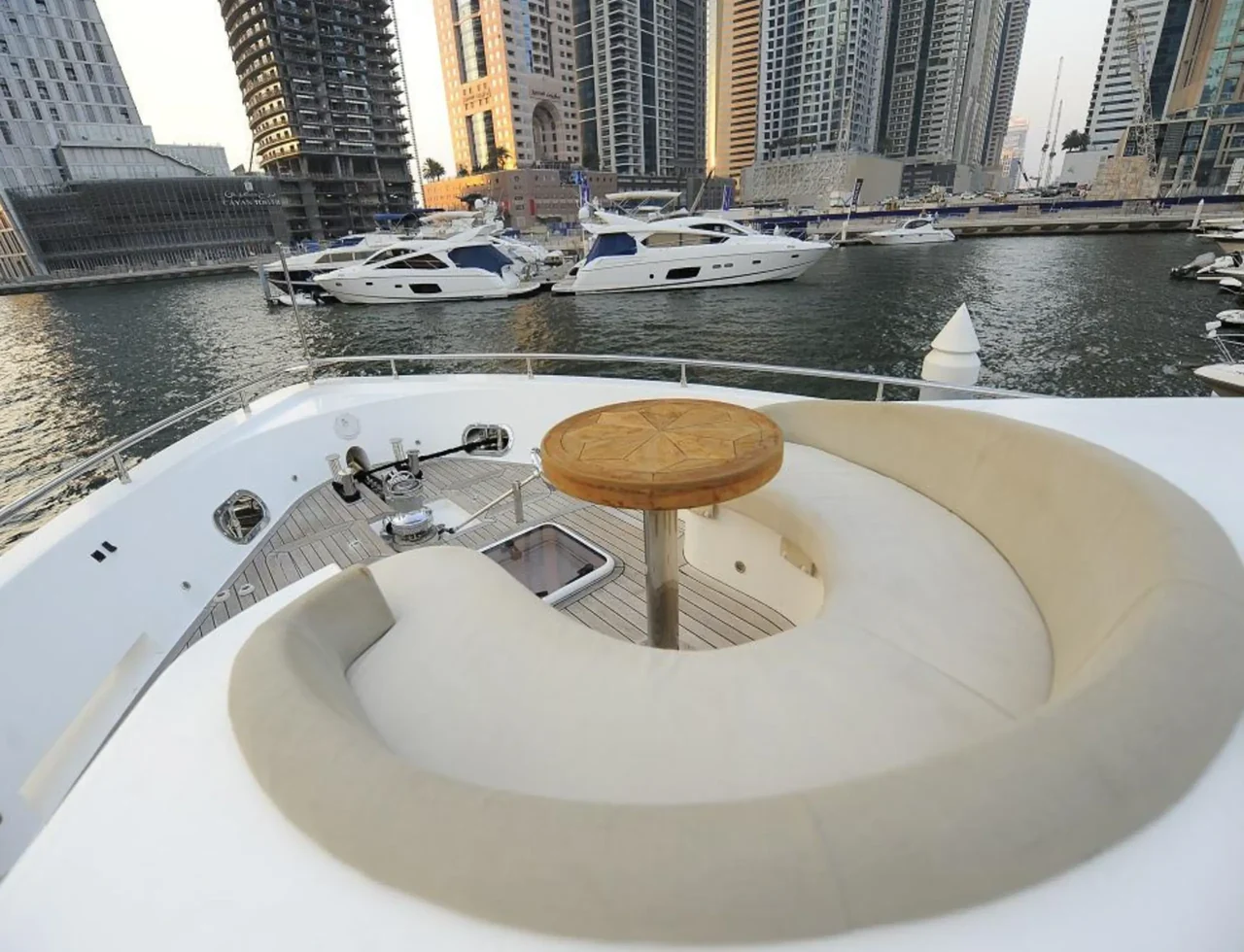 Rounded flybridge seating and table on 101 ft Infinity