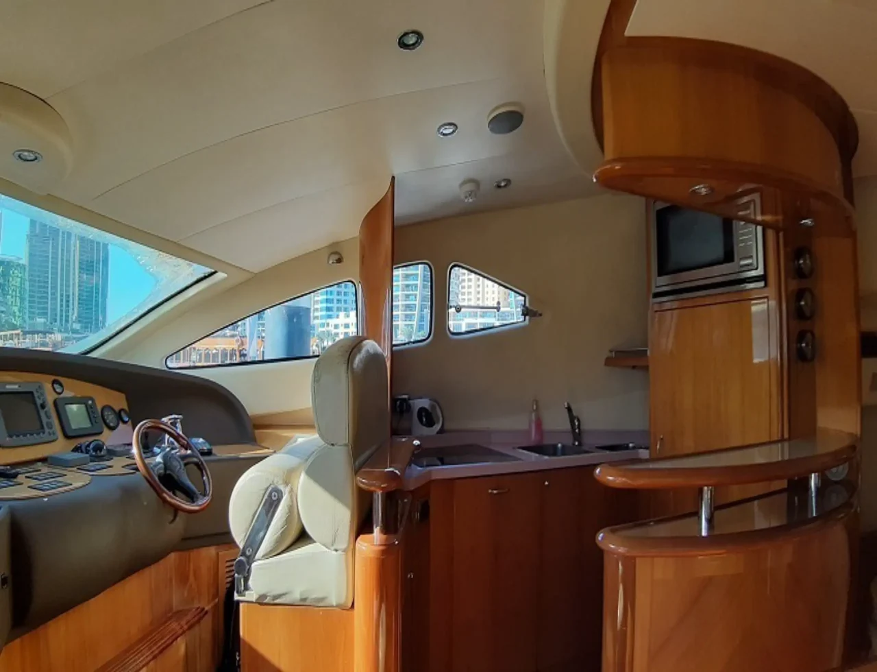 Wood-finished galley and helm on 60ft Aicon