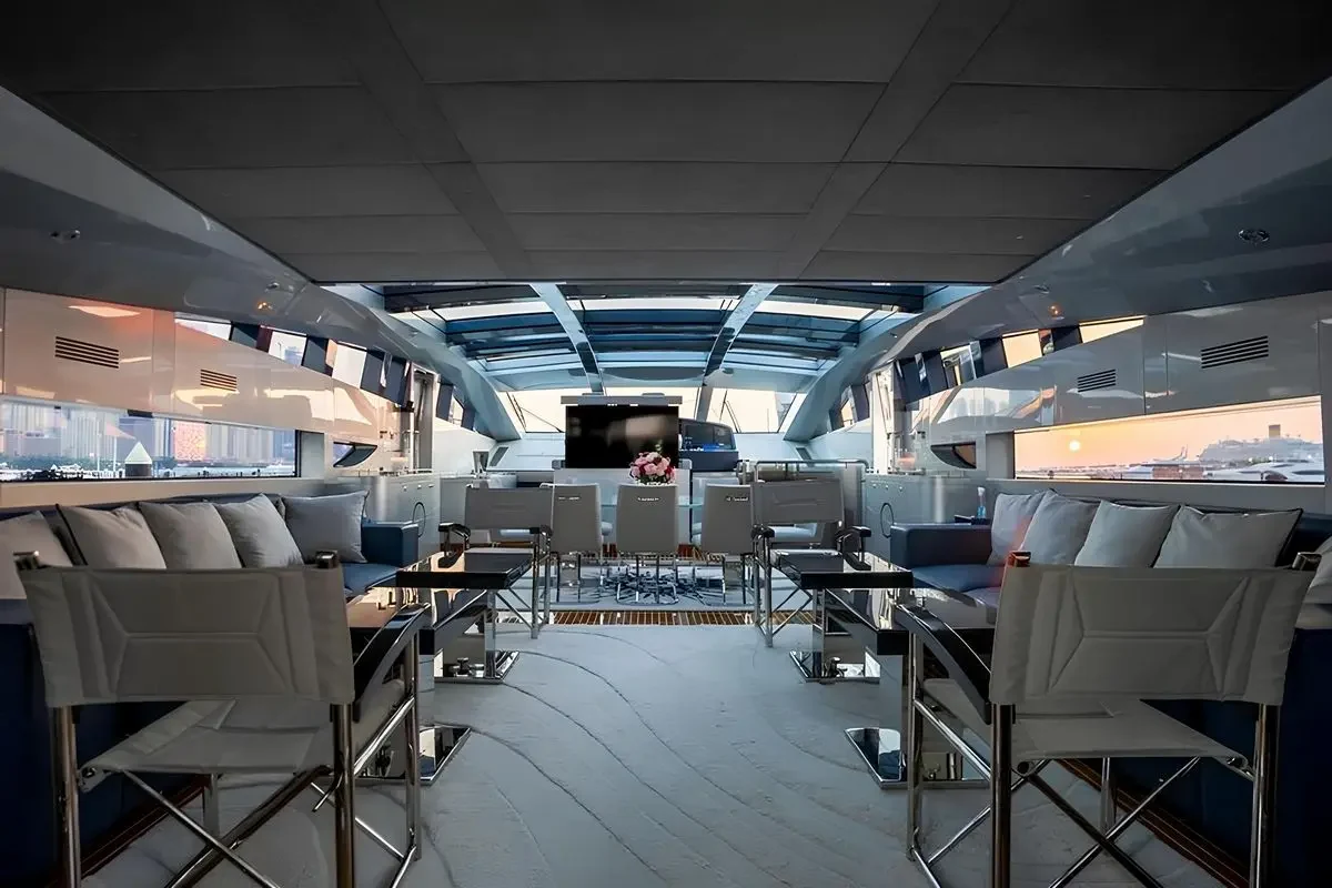 Spacious interior lounge and dining area on Baglietto 110 yacht with panoramic windows and contemporary design